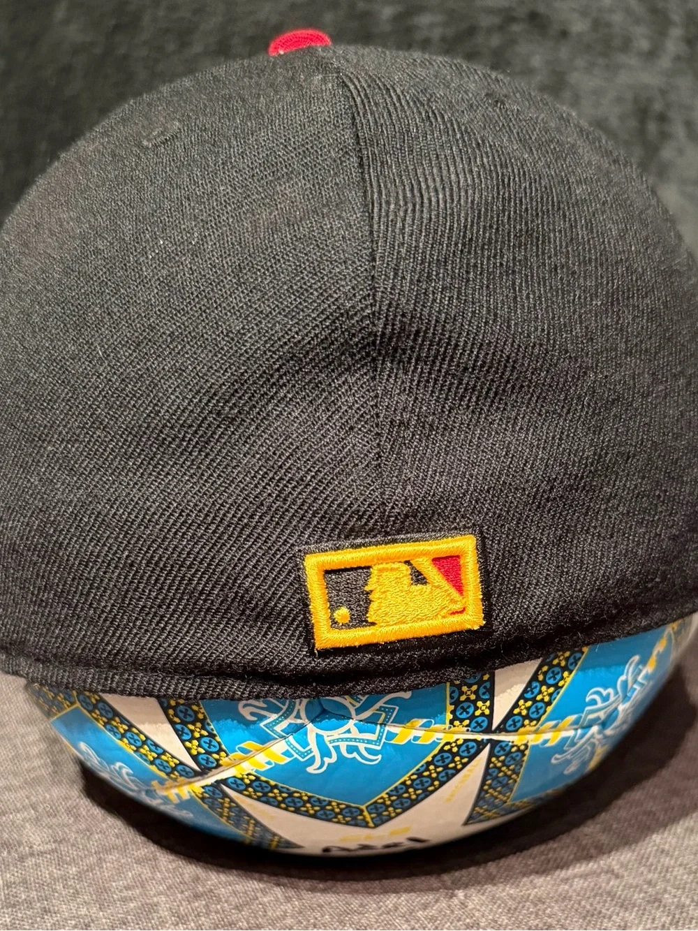 New Era Black Cap with Red Brim and Yellow Logo
